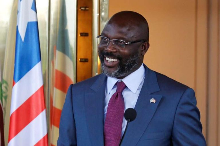 Liberia's President George Weah laughs during a news conference at Presidential palace in Abidjan